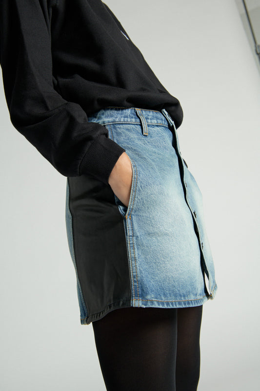 Photo of a model wearing the A-line Denim Skirt with Leather in Medium Blue with Black 